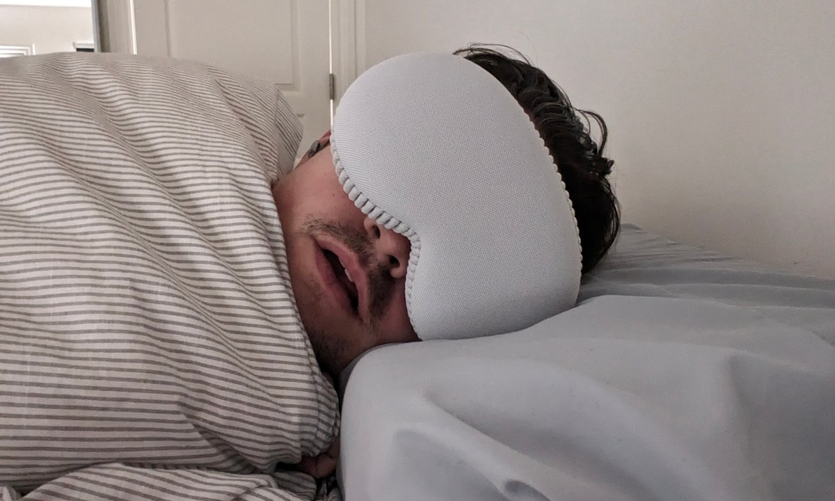 Michael
taking a nap in bed, wearing a Vision Pro with protective cover as a
sleeping mask.